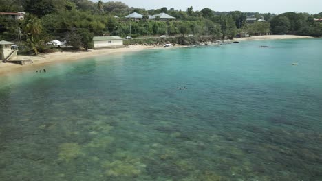 Low-flying-aerial-view-of-an-amazing-shallow-reef-beach-on-the-tropical-island-of-Tobago