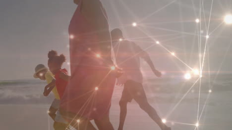 man lunging forward reaching female partner on wet sand, showing network overlay for technology