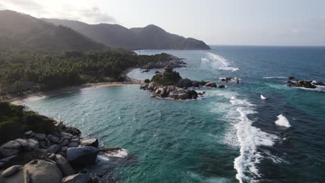 Drone-flyover-scenic-landscape-from-Cabo-San-Juan-toward-wooden-hut-viewpoint,-Tayrona-National-Natural-Park