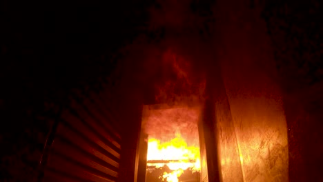 flames erupt inside a fire training simulator and flashover along the ceiling