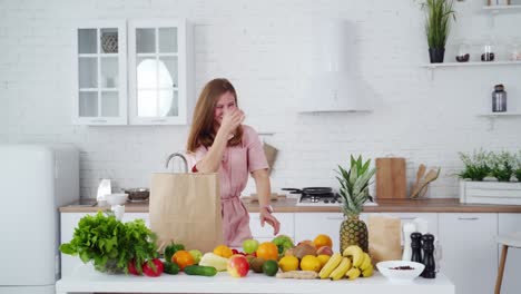 Young woman in modern kitchen. Portrait of a smiling happy girl throwing apples in kitchen