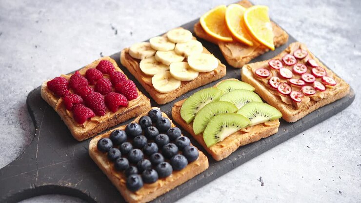 Wholegrain bread slices with peanut butter and various fruits