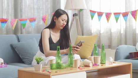 mujer mirando el teléfono después de una fiesta
