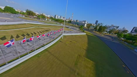 Aerial-fpv-flight-over-PLAZA-DE-LA-BANDERA-with-waving-flags-during-Beautiful-sunny-day-in-Santo-Domingo