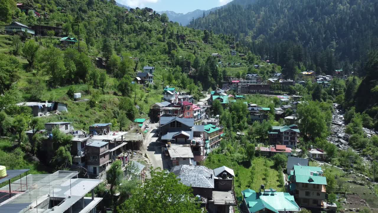 Aerial view short of Jibhi Himachal Pradesh in India. Houses and trees in the mountainous area. Faguli festival is one of the biggest festival in Jibhi. The traditional houses here have stone roofs.