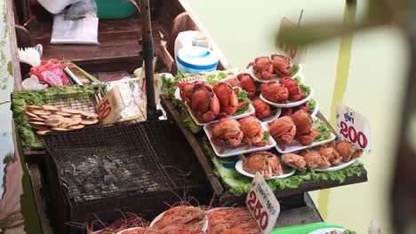 bangkok, thailand - cooked crabs and shrimps for sale in a canal boat - closeup shot
