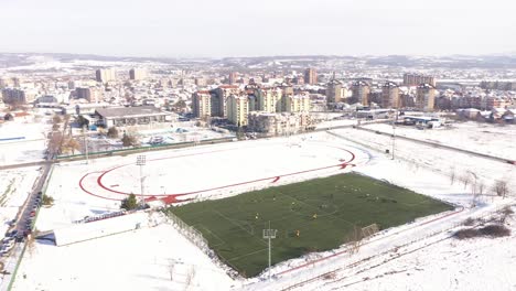 football club on the winter preparations on the artificial grass , drone 4k