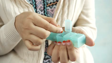 woman using a pill organizer