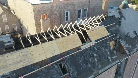 Aerial-drone-forward-moving-shot-of-damagrd-roof-structure-after-been-burned-down-due-to-fire