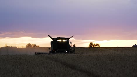 combine harvester in sunlight at sunset