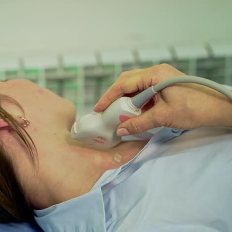 ultrasound examination to a patient. doctor's hands holding medical sensor on patient's body while making ultrasound in clinic.