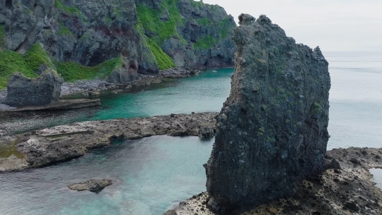 Aerial fly scenic stone cliff in Japanese Hokkaido secret beach, natural environment, travel spot in Hokkaido