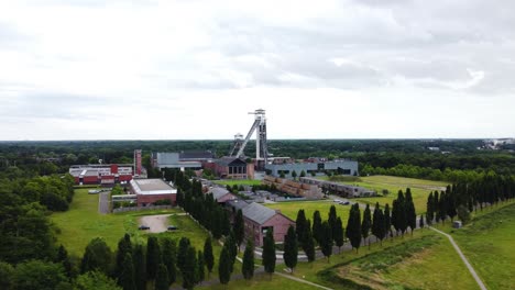 industrial complex with tower and green surroundings, aerial drone view