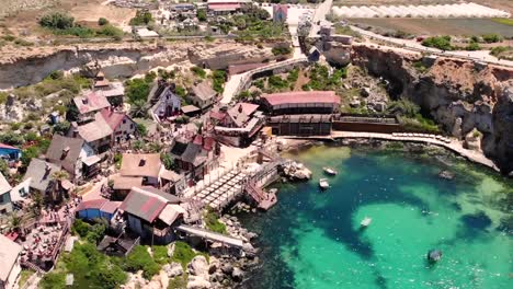 Small-fishing-village-in-mediterranean-sea-drone-pan-shot-fly-backward