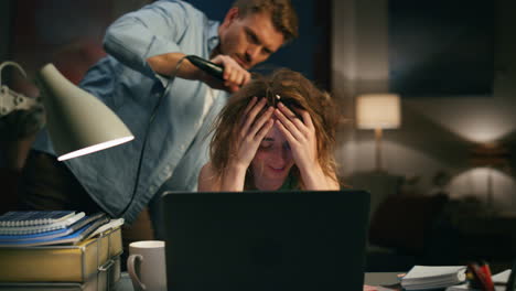 Man-drying-laughing-lady-at-remote-workplace-closeup.-Woman-trying-ignore-spouse