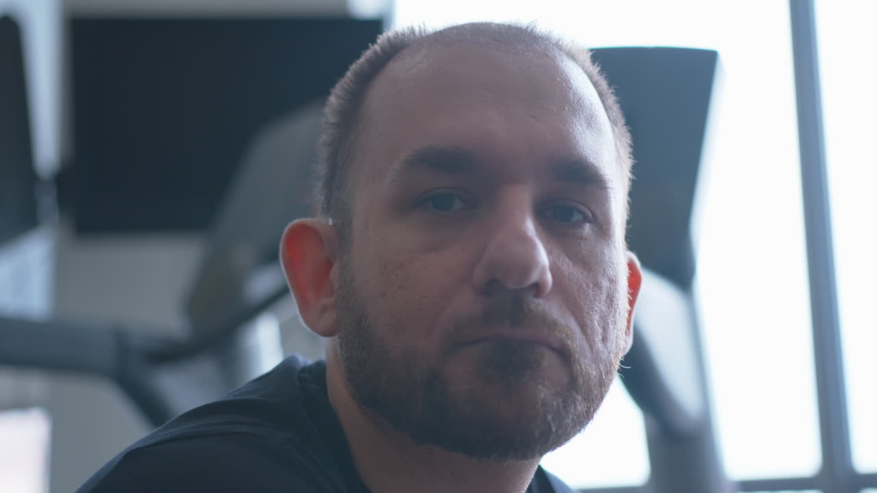 Close Up Pan Right of a Serious Man Looking Into the Camera in Slow Motion