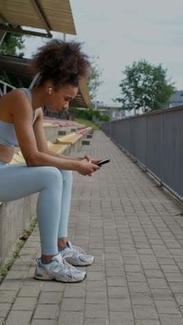 woman resting on stadium bleachers