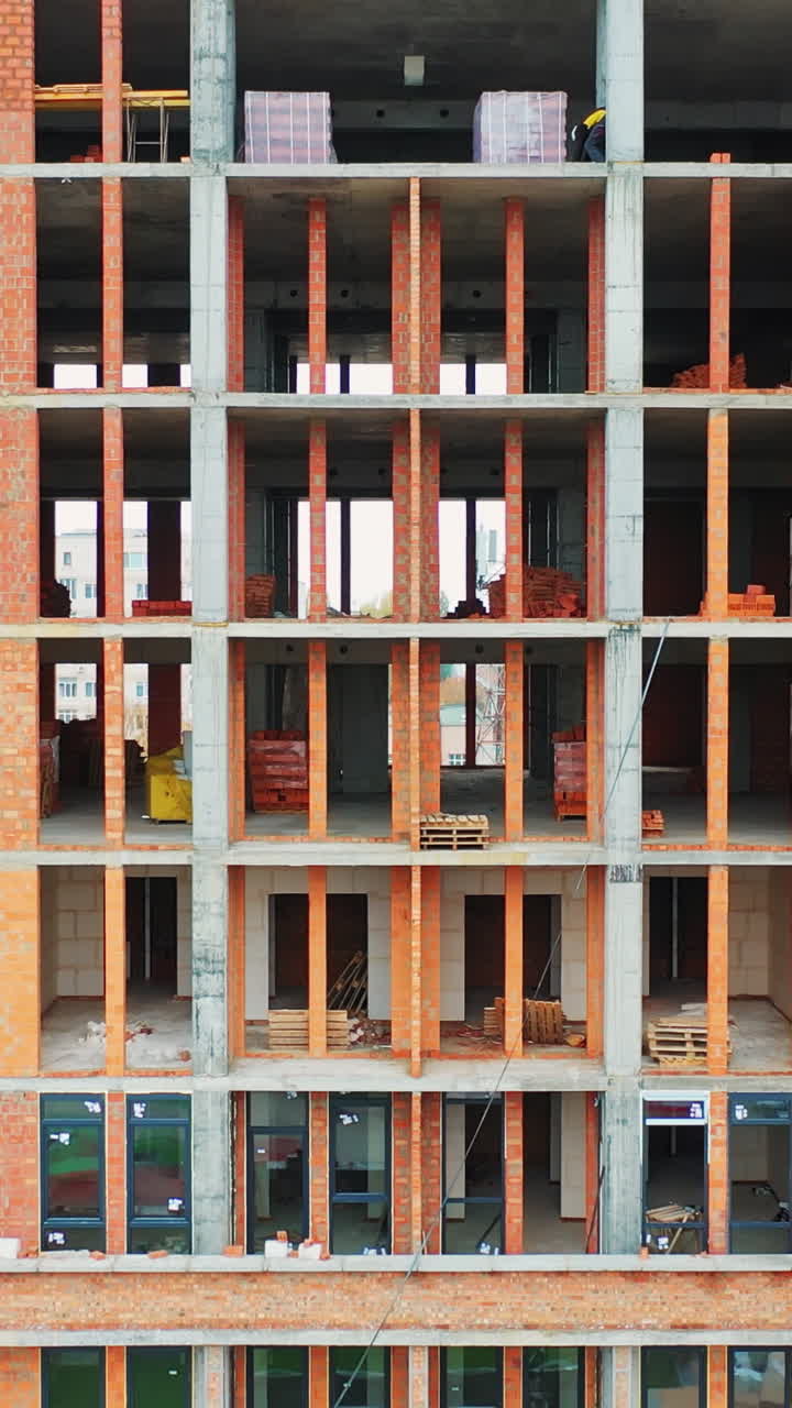 Construction of a residential apartment complex. Aerial view. Vertical video