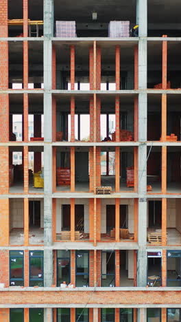 construction of a residential apartment complex. aerial view. vertical video