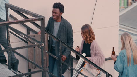 group-of-friends-walking-up-fire-escape-stairs-to-rooftop-party-chatting-sharing-excitement-preparing-for-weekend-celebration-in-city