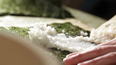 putting rice on nori