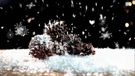 snow falling on pine cones