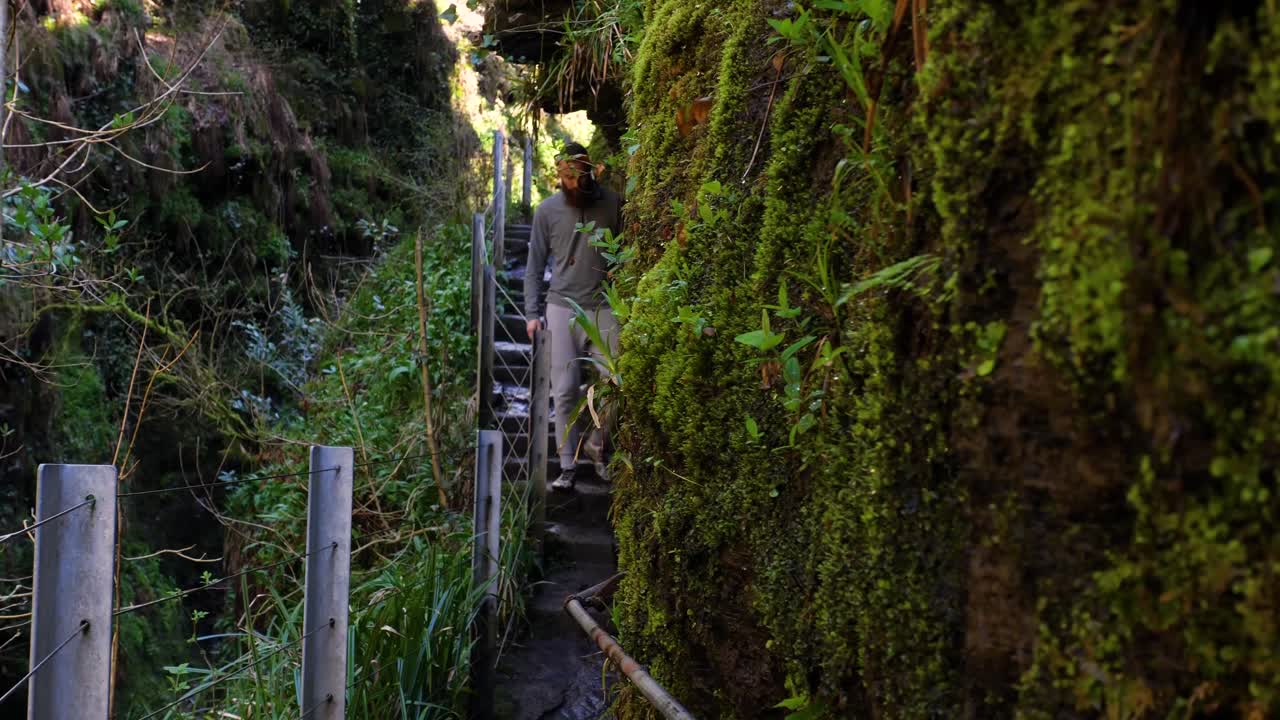 언덕 옆에 새겨진 길을 천천히 걷고 있는 청년