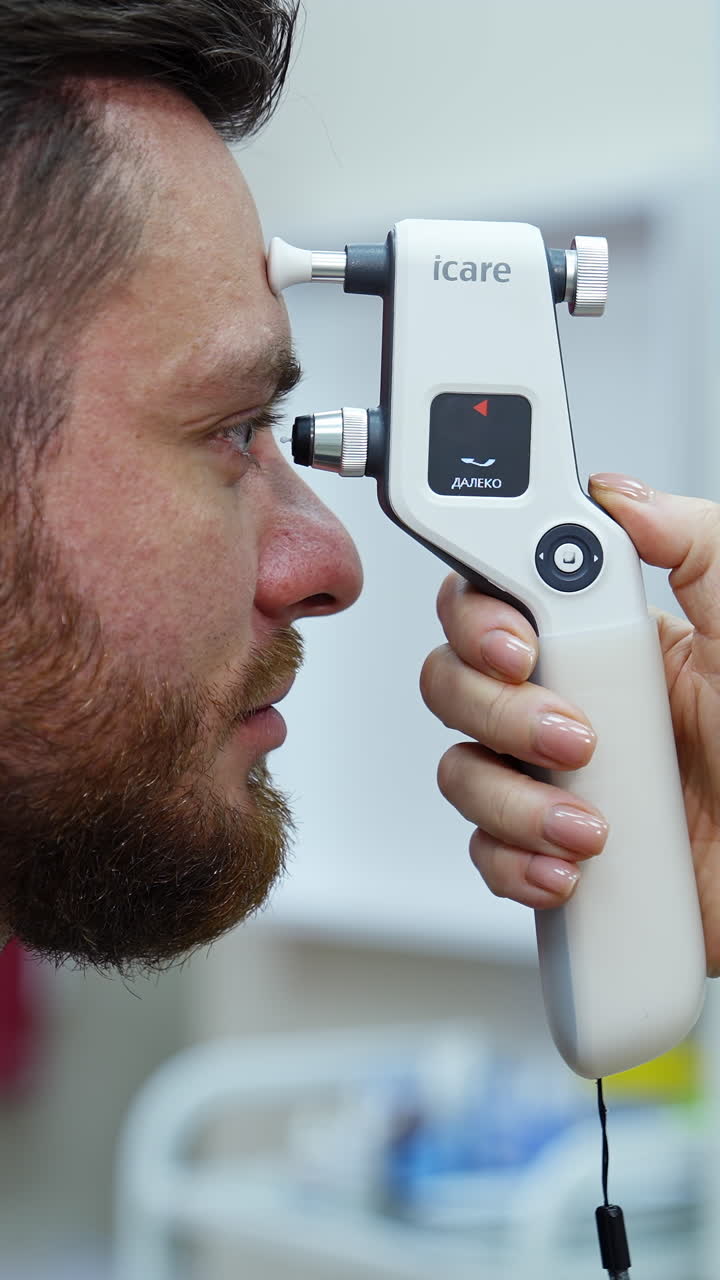 Doctor examining eyesight of patient. Man looking at eye test machine in ophthalmologist. Vertical video