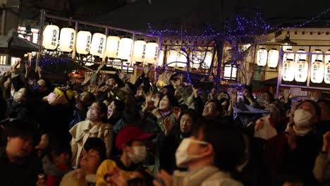 people gathered outdoors for a nighttime celebration