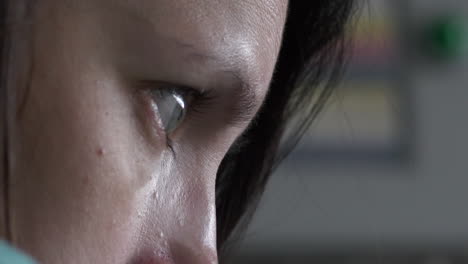 extreme close up side view of caucasian woman staring with dramatic eyes