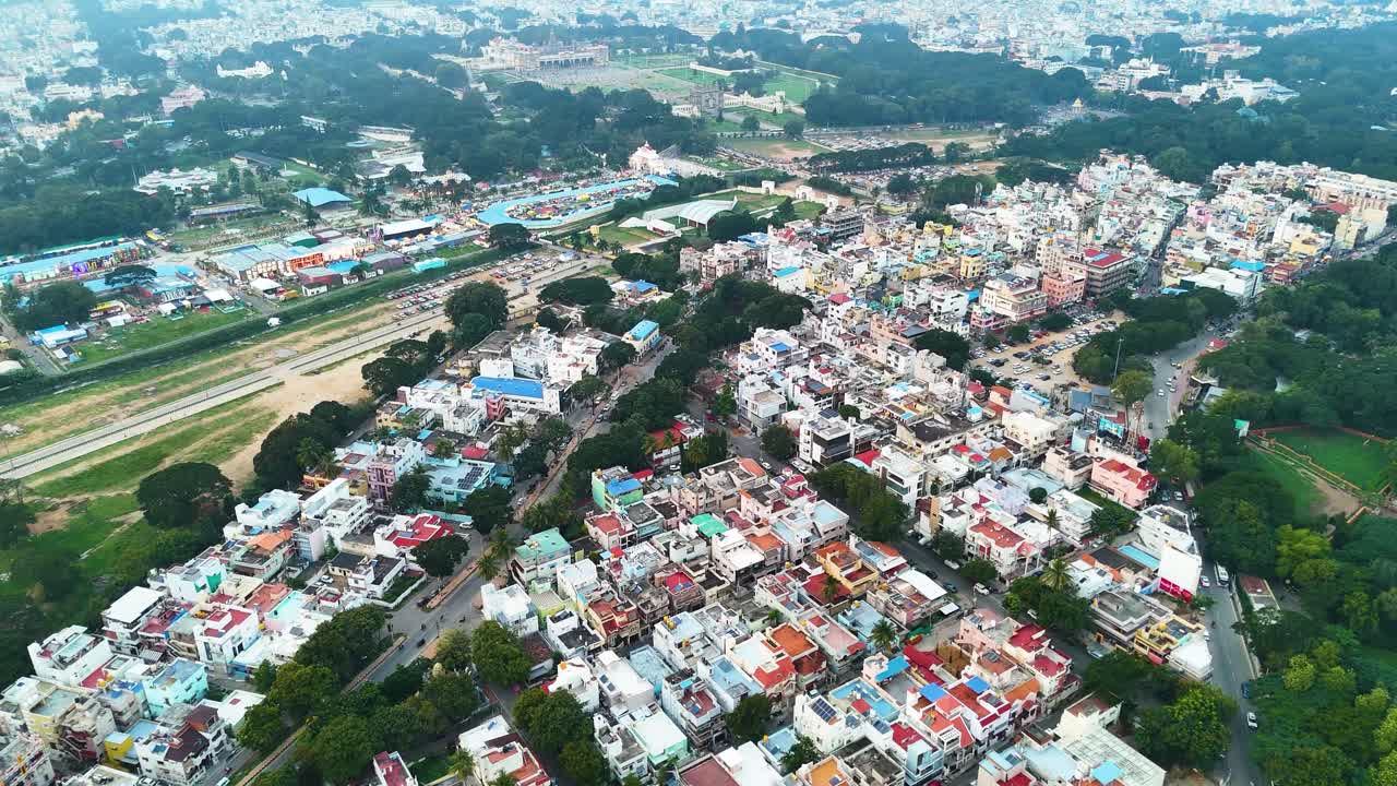 Aerial view of Mysuru city in Karnataka, showcasing colorful urban homes, lush greenery, and sprawling cityscapes. A dynamic mix of modernity and tradition in South India.