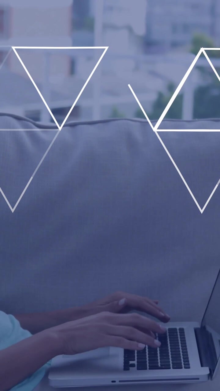Using laptop on couch, woman with geometric shapes animation around her