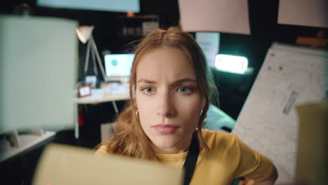 Focused-female-manager-working-with-scrum-board-in-hipster-office.