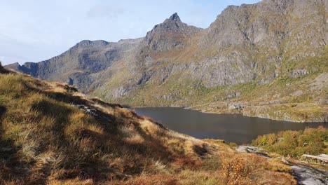 blue lake in front of rugged mountains in nord norway