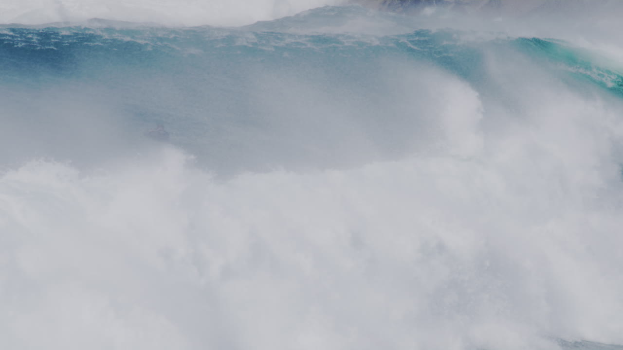 Close-up of crashing waves on the Sydney coastline, with water mist and turbulent sea action.