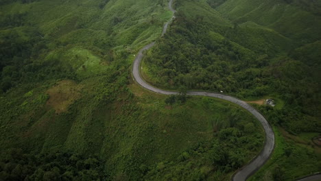aerial view flying above lush green tropical rain forest mountain with rain cloud cover during the rainy season on the doi phuka mountain reserved national park the northern thailand