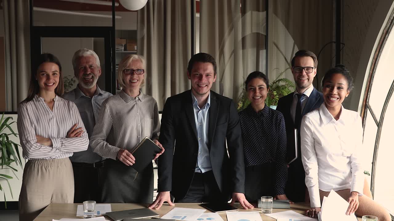 Skilled happy multiracial diverse colleagues posing in office.