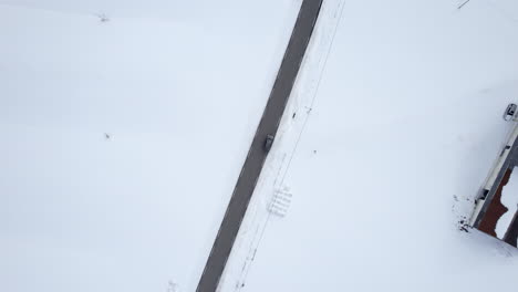 suv parked at norwegian country road in northern norway, bird eye view ascending drone shot