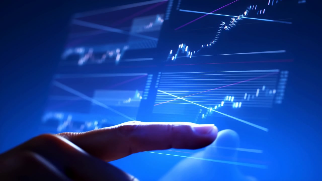Close view of a hand pressing a bright digital display with rising charts, blue data lines, and an abstract technology background for finance and analysis