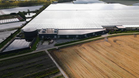 industrial facility with massive greenhouses, aerial drone view