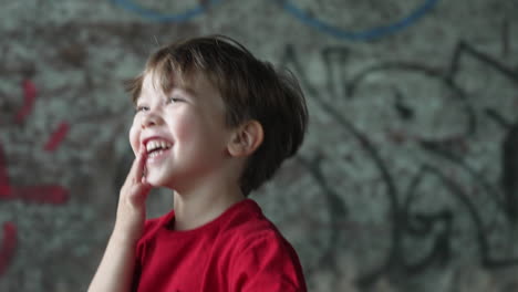 Slow-motion-video-of-a-young-little-boy-in-a-red-T-shirt-looking-very-excited-and-laughing-in-joy