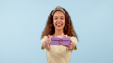 gift, excited woman and pointing at box in studio