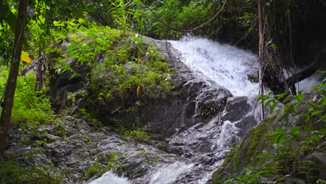 beautiful cascading waterfall running down rocks in jungle