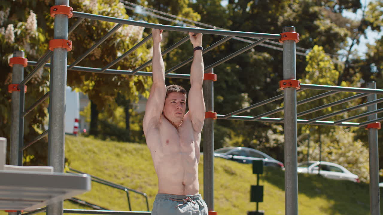 Athletic caucasian topless muscular man training abs doing abdominal crunches strength gymnastics