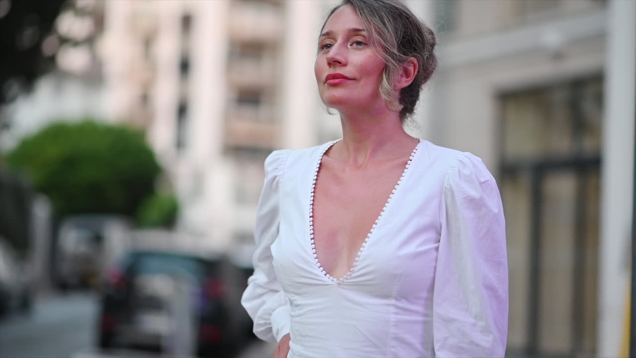 Woman in white dress posing in Cannes, France