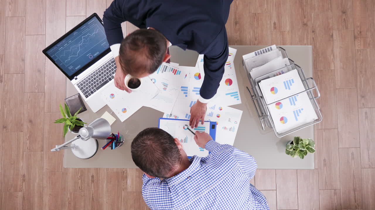 Businessmen discussing charts at the office