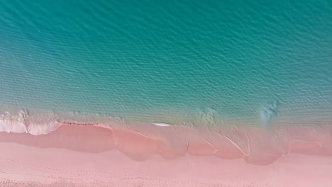pink sand beach with turquoise water