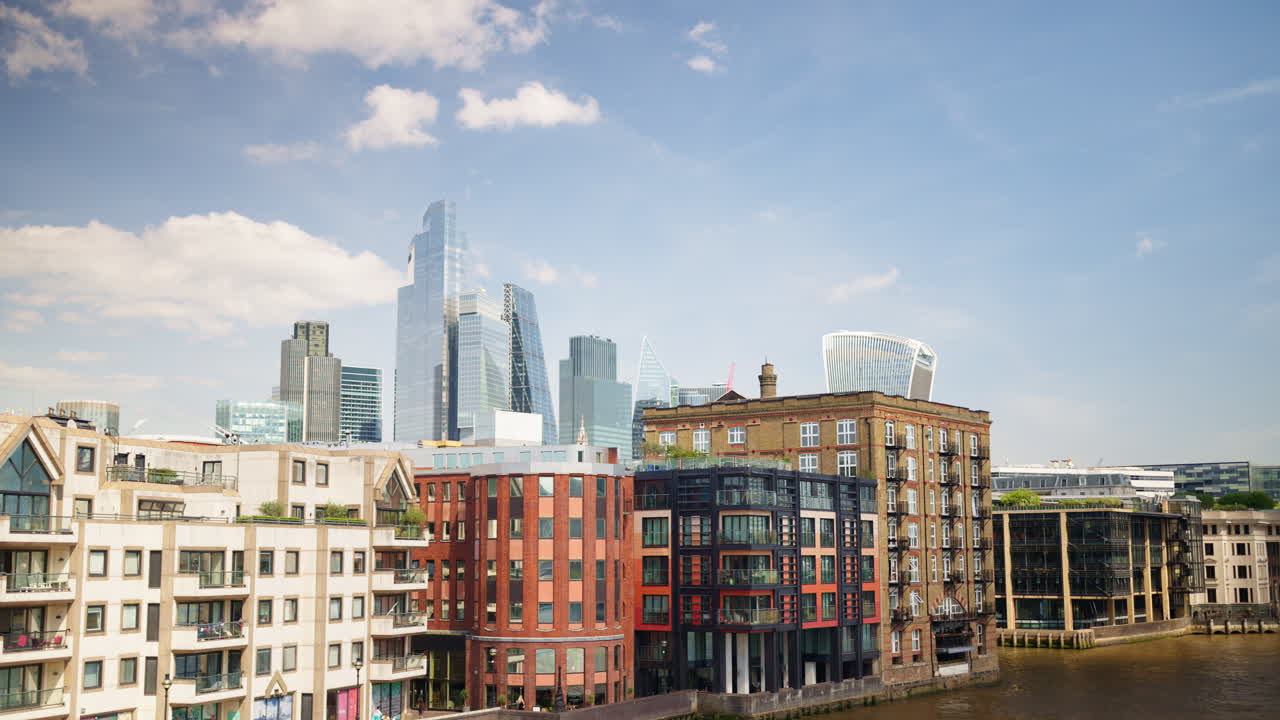 View of London's skyline with glass skyscrapers and riverfront buildings along the Thames, London, England