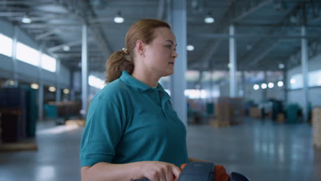 female storehouse vehicle operator transporting shipment pallets working process