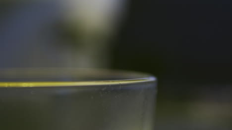 pulling focus from a glass to a coffee presser.